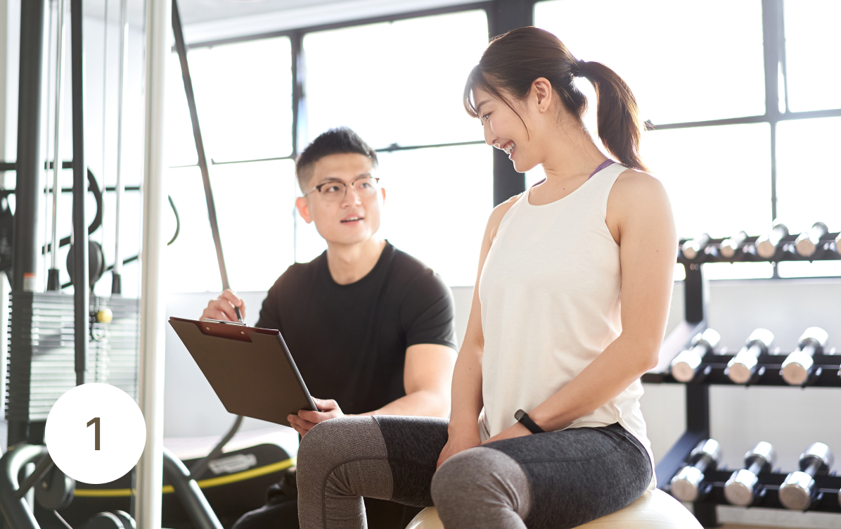 personal trainer consulting with client
